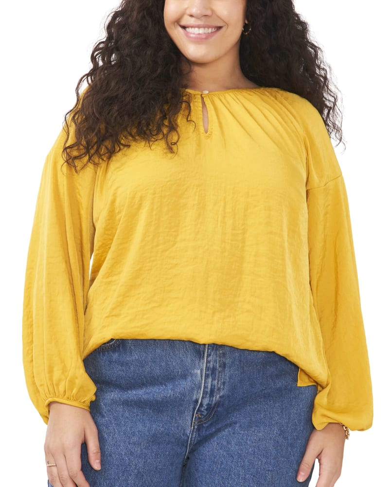 Front of a model wearing a size 1X Aria Peasant Blouse in MOSAIC MUSTARD by Vince Camuto. | dia_product_style_image_id:261016